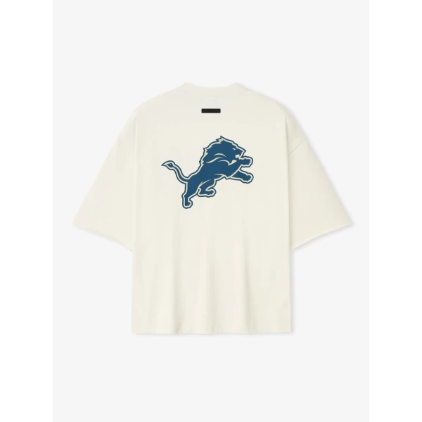 Fear of God Essentials Lions 90s 3/4 Sleeve Football Tee in Cream White | T-shirts & vests | Coveti