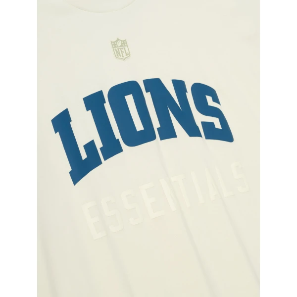 Fear of God Essentials Lions 90s 3/4 Sleeve Football Tee in Cream White | T-shirts & vests | Coveti