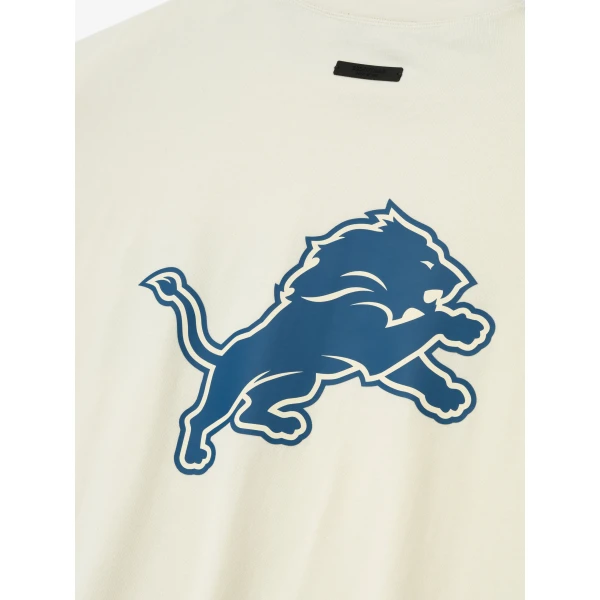 Fear of God Essentials Lions 90s 3/4 Sleeve Football Tee in Cream White | T-shirts & vests | Coveti