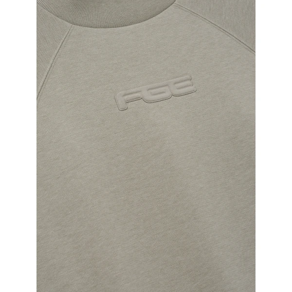 Fear of God Essentials Pique 90s Relaxed Mockneck Raglan Long Sleeve Tee in Pyrite Heather | T-shirts & vests | Coveti