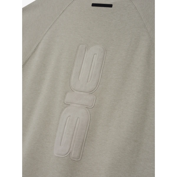 Fear of God Essentials Pique 90s Relaxed Mockneck Raglan Long Sleeve Tee in Pyrite Heather | T-shirts & vests | Coveti