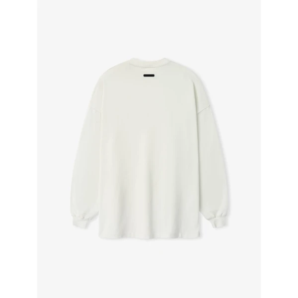 Fear of God Essentials Signature 90s Relaxed Long Sleeve Tee in Washed Ivory | T-shirts & vests | Coveti