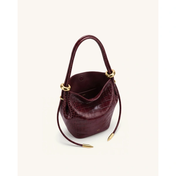JW PEI Ellie Metal Ring Embellished Bucket Bag in Burgundy Croc | Bucket Bags | Coveti