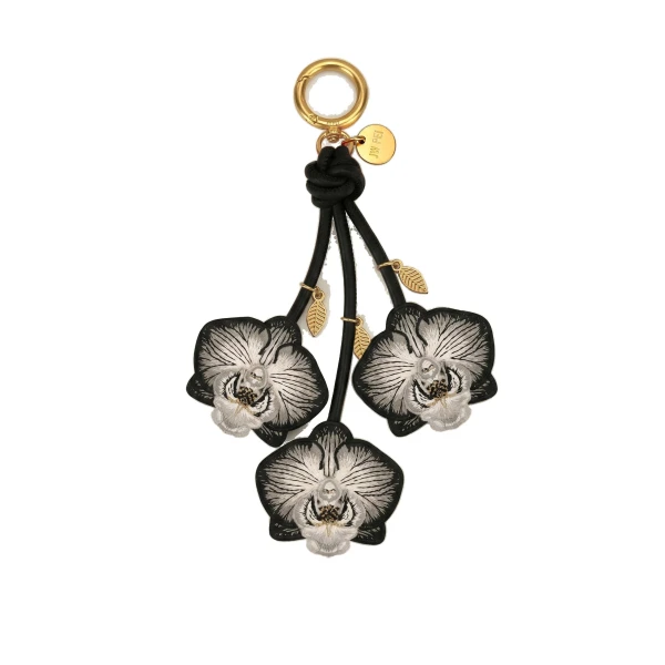 JW PEI Orchid Bag Charm in Black | Bag Charms | Coveti