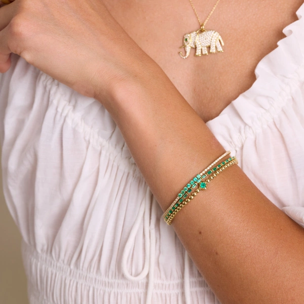 Jennifer Meyer 4 Prong Diamond Tennis Bracelet with Large Emerald Accent in 18K Yellow Gold | Fine Bracelets | Coveti