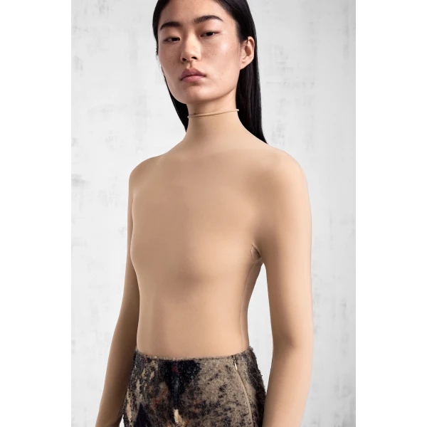Maison Margiela Technical Jersey Turtleneck Bodysuit in Nude | Bodysuit | Coveti