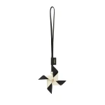Valextra Pinwheel Charm in Black and Pergamena White | Bag charms | Coveti