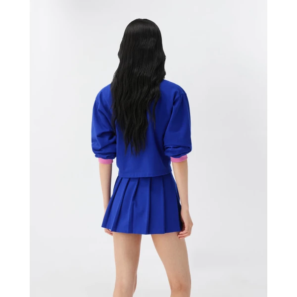 Versace Embroidered-Logo Cotton Piqué Pleated Mini Skirt in Blue, view 3 | Pleated Skirts